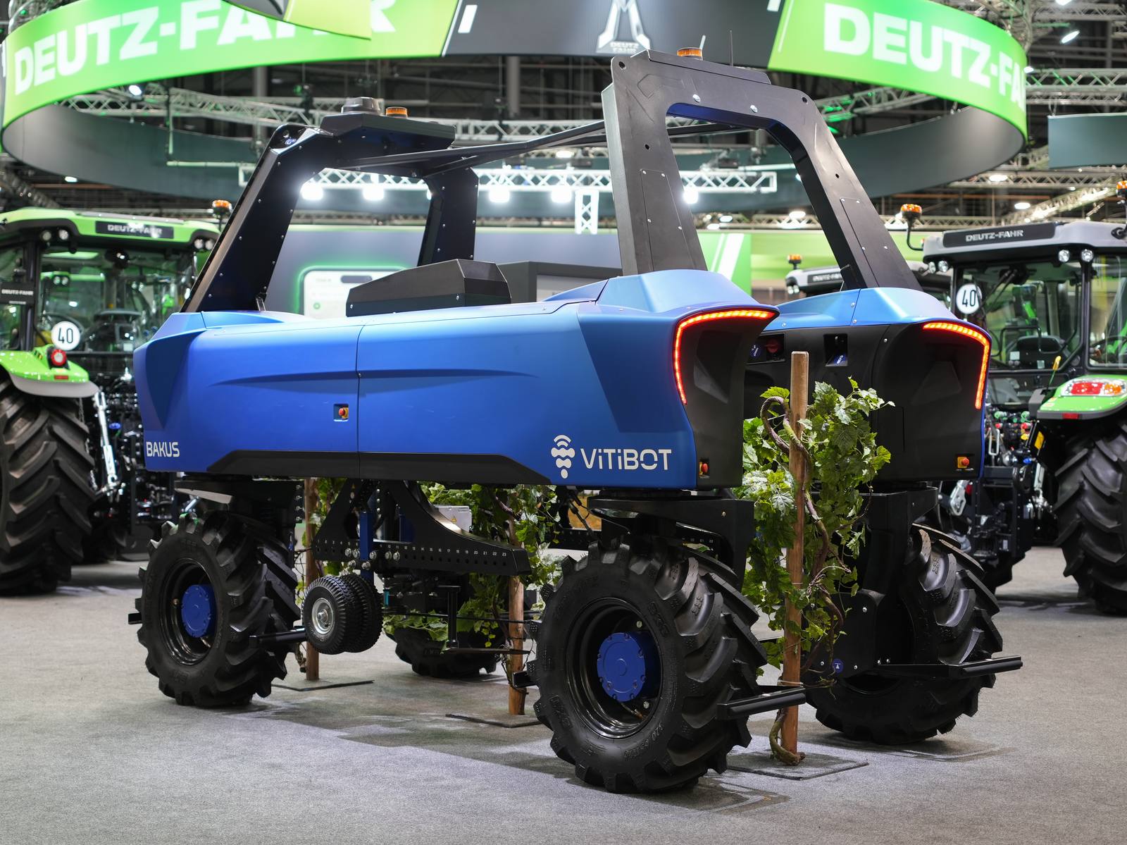 A VitiBot Bakus-P75L vineyard robot on display at Agritechnica 2025. Jamie Goode filmed a Bakus performing under-vine cultivation in Domaine Louis Latour's Corton-Charlemagne Grand Cru in April 2026, praising its ability to turn in narrow headlands.